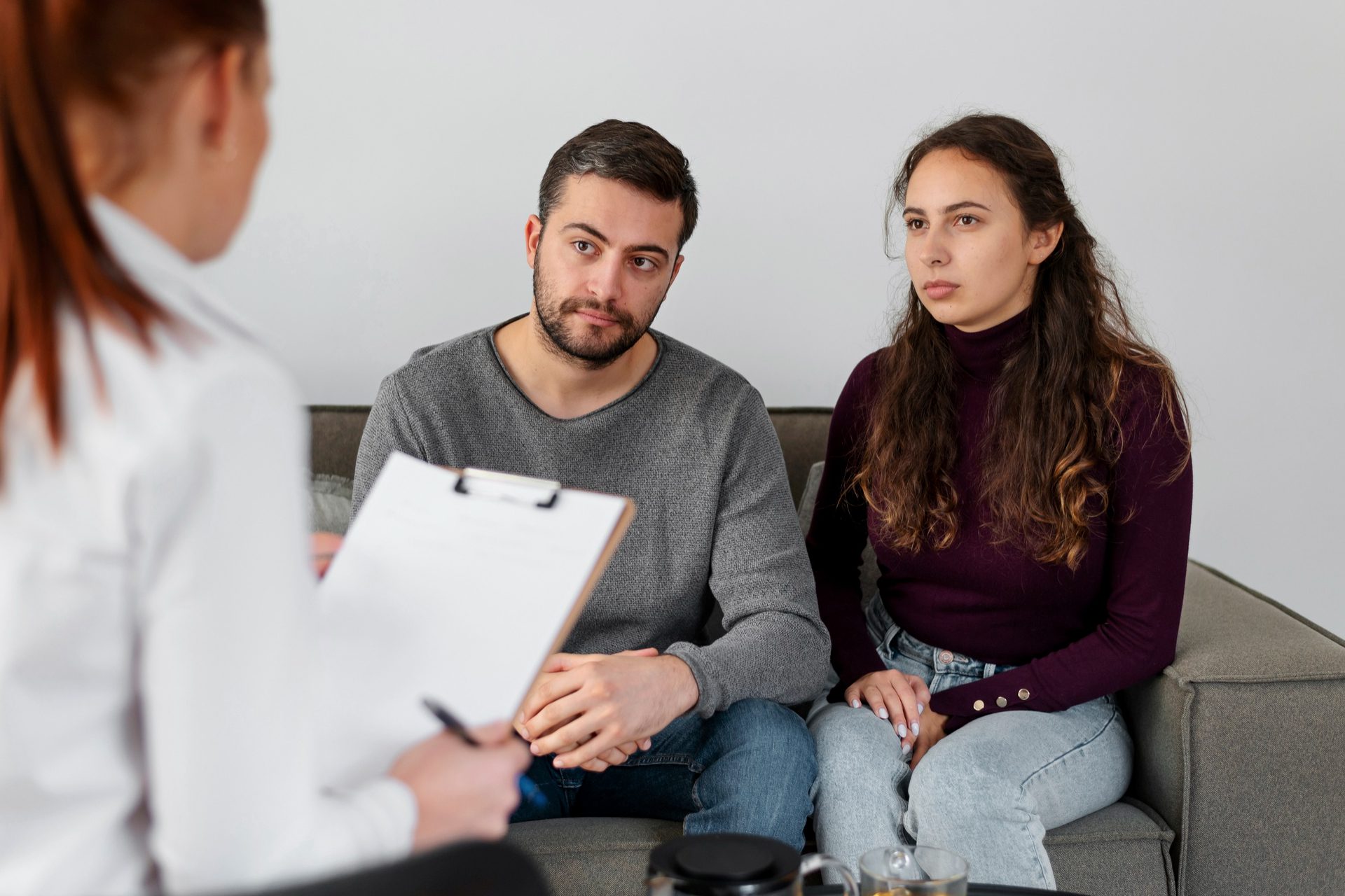 Close up people discussing with therapist